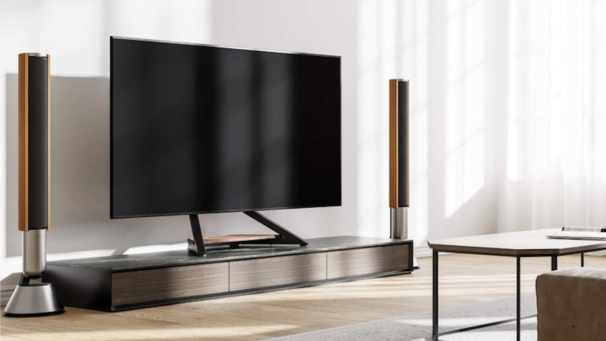  The Fitueyes Eiffel TV stand pictured holding a large TV in an upmarket living room. 