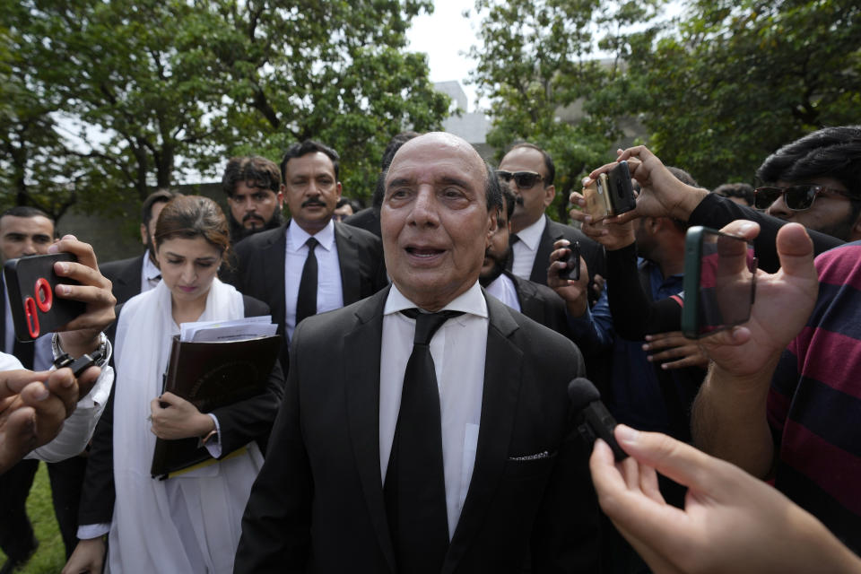 Latif Khoosa, center, a leading lawyer of imprisoned former Prime Minister Imran Khan's legal team, talks to media as he leaves the Islamabad High Court in Islamabad, Pakistan, Thursday, Aug. 24, 2023. A court in Pakistan's capital is likely to issue a crucial ruling Thursday on an appeal from the country's imprisoned former Prime Minister Khan against his recent conviction and three-year sentence in a graft case, one of his lawyers said. (AP Photo/Anjum Naveed)