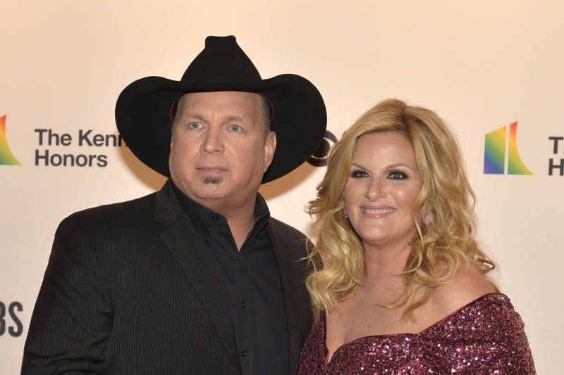 Trisha Yearwood, seen with Garth Brooks, will receive the inaugural June Carter Cash Humanitarian Award. File Photo by Mike Theiler/UPI