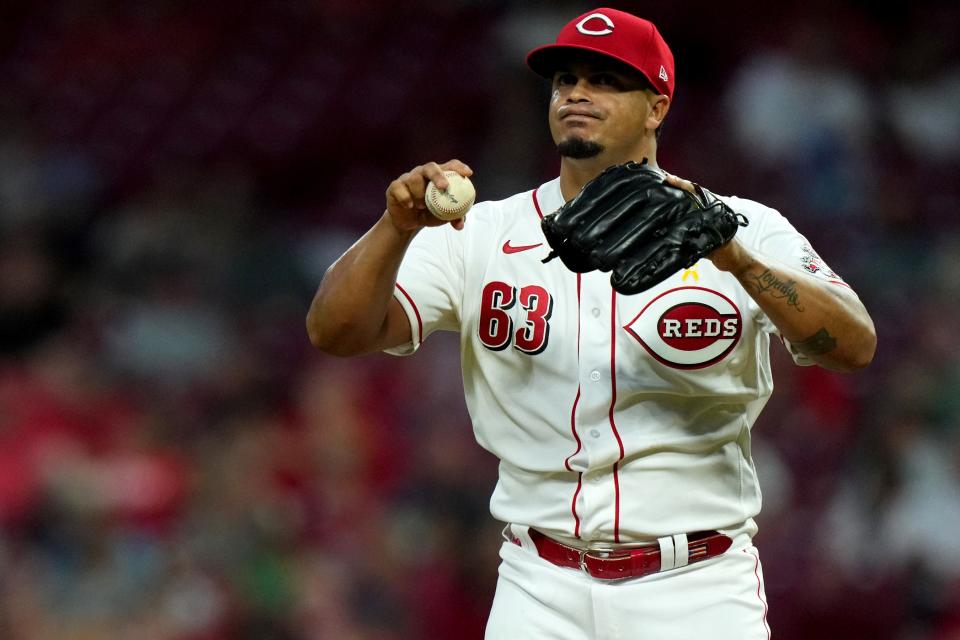 Cincinnati Reds starting pitcher Fernando Cruz (63) gets set on the mound mound between pitches during the sixth inning of a baseball game against the Colorado Rockies, Friday, Sept. 2, 2022, at Great American Ball Park in Cincinnati. The appearance marked his major-league debut.