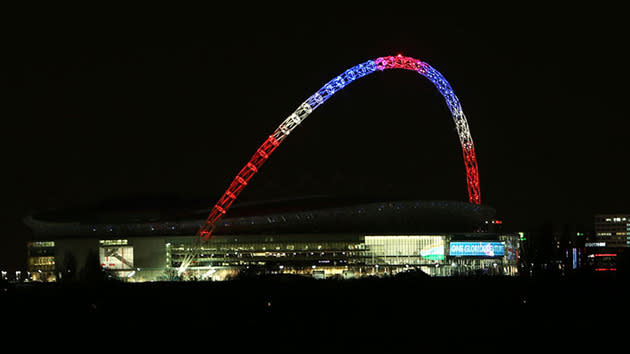 The famous arch at London's Wembley Stadium is lit up in French colours.