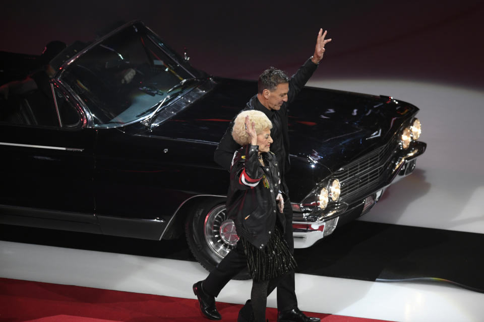 Former Chicago Blackhawks great Chris Chelios and his mother Susan ride in a car while entering the United Center during a ceremony to retire his jersey before an NHL hockey game between the Chicago Blackhawks and Detroit Red Wings Sunday, Feb. 25, 2024, in Chicago. (AP Photo/Paul Beaty)