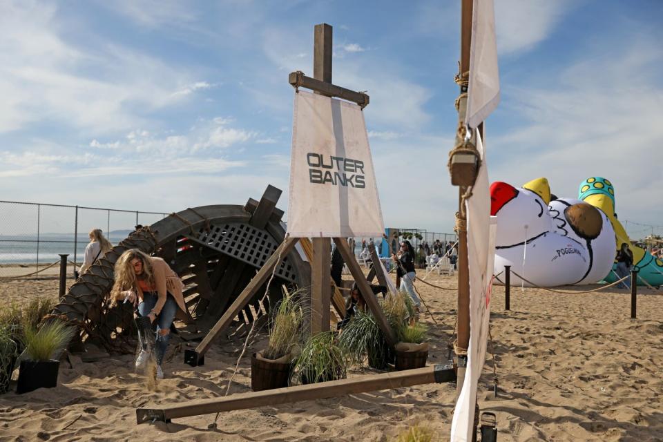 Attendees dig for bullion coin at the Buried Treasure prop at Poguelandia.