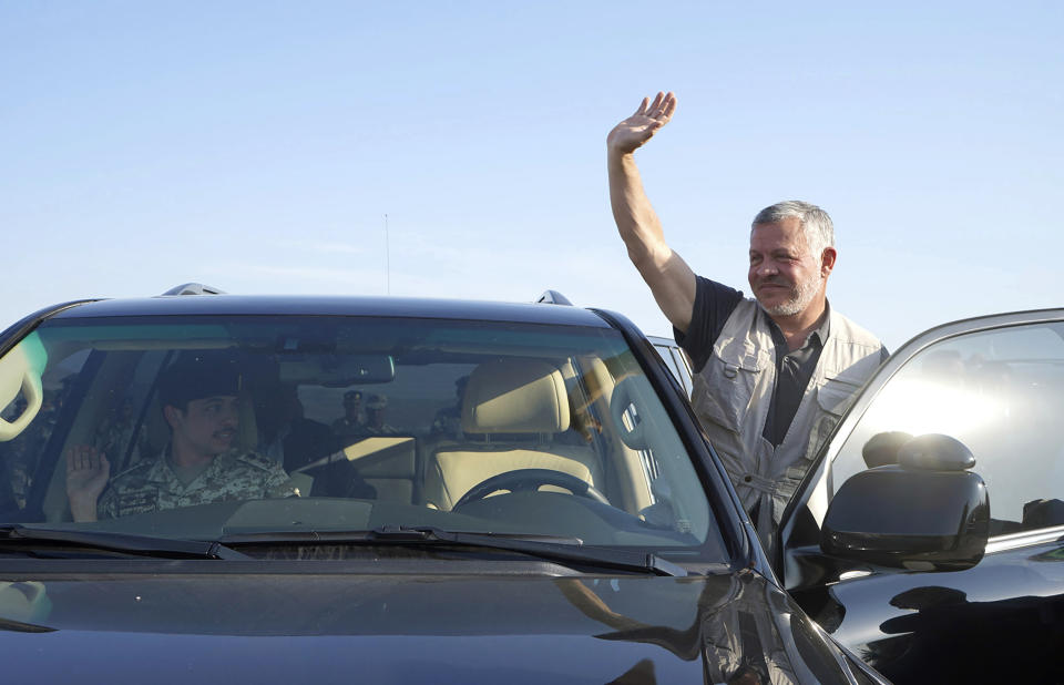 Jordan’s King Abdullah II, waves during a tour of the Baqura enclave formerly leased by Israel, with Crown Prince Hussein, left, and military officers, Monday, Nov. 11, 2019. Jordan’s decision not to renew the leases on the Baqura and Ghamr enclaves, known in Hebrew as Naharayim and Tzofar, were a fresh blow to Israel and Jordan’s rocky relations 25 years after the two countries signed a peace deal. (Yousef Allan/Jordanian Royal Court via AP)