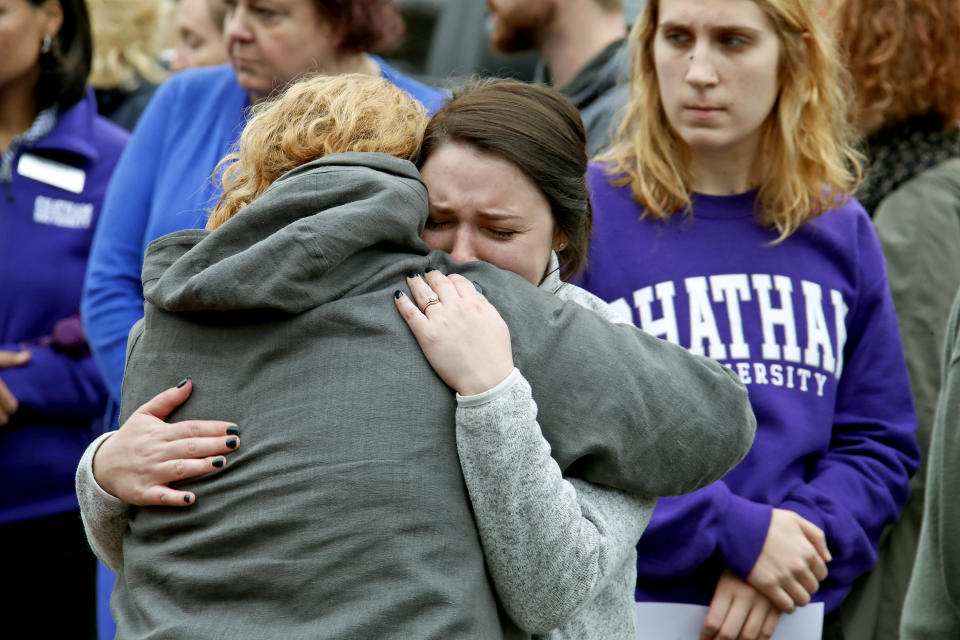 Chatham University students hug during a visit Thursday, Nov. 1, 2018, to a makeshift memorial outside the Tree of Life synagogue dedicated to the 11 people killed Oct. 27 while worshipping, in the Squirrel Hill neighborhood of Pittsburgh. (AP Photo/Gene J. Puskar)