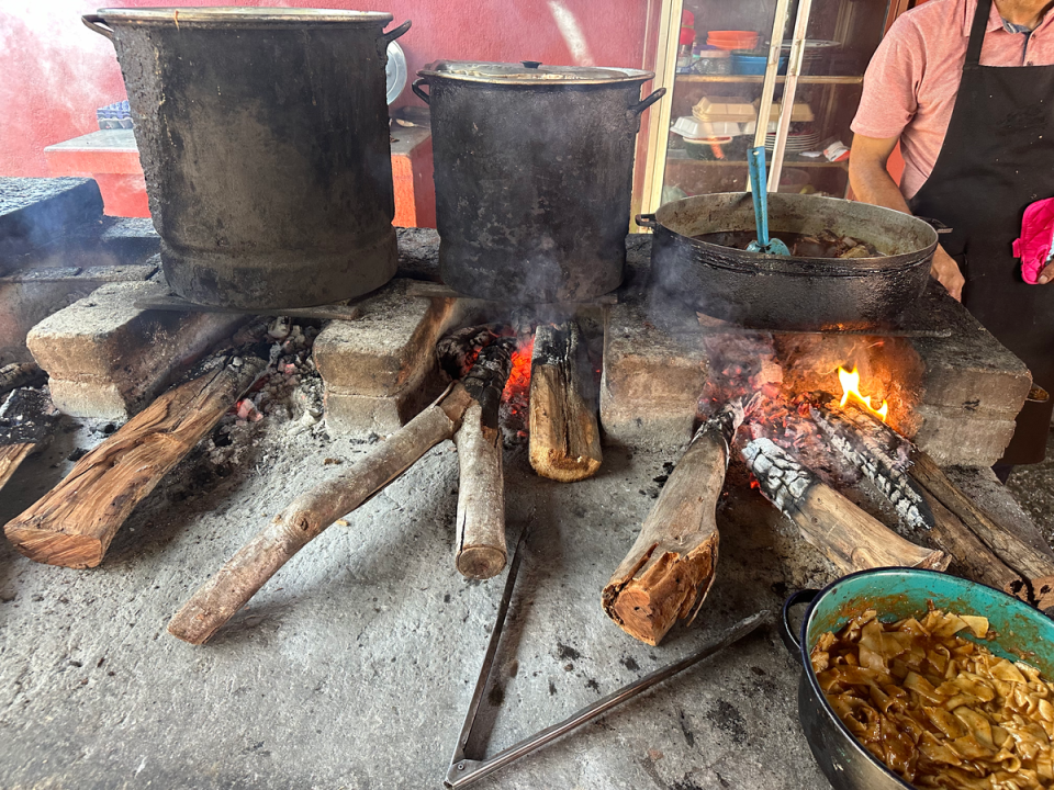 Food is slow-cooked over a fire (Chelsea Ritschel)