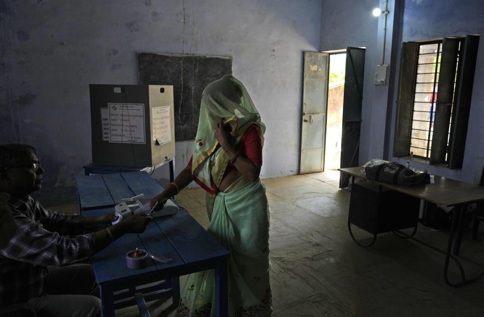 A woman shows voting slip before she casts her vote during the first round of voting of India's national election in Behror, Rajasthan state, India, Friday, April 19, 2024. Nearly 970 million voters will elect 543 members for the lower house of Parliament for five years, during staggered elections that will run until June 1. (AP Photo/Manish Swarup)