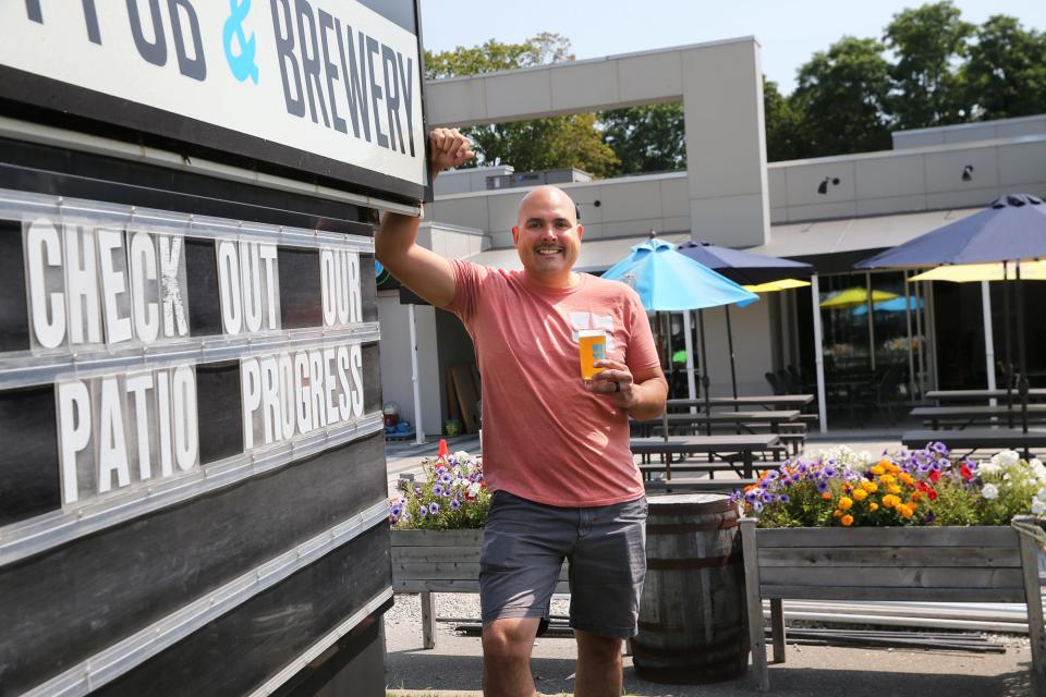 Alex Gilbert Aviles, owner of WHYM Craft Pub & Brewery, raises a glass to the brand-new patio, continuing a trend of places along Route 1 who have leaned into outdoor dining since the pandemic.