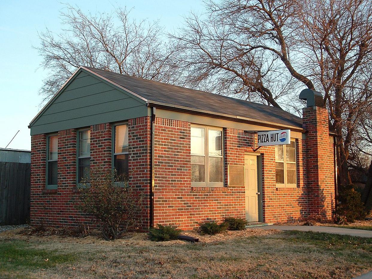 First Pizza Hut building at Wichita State University Campus, Kansas. This was opened on June 15, 1958 by two brothers Frank and Dan Carney attending the University of Wichita at that time, at the corner of Kellogg and Bluff. This building was moved to the