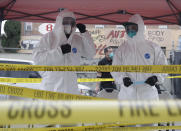 FILE - In this Monday, April 20, 2020, file photo members with Los Angeles Fire Department wear protective equipment at a COVID-19 testing site in the Skid Row district in Los Angeles. Coronavirus cases have surged to record levels in the Los Angeles area. Health officials said Wednesday, July 15, 2020, the nation's most populous county is in "an alarming and dangerous phase" that if not reversed could overwhelm intensive care units and usher in more sweeping closures. The three-day average of hospital patients in the county is above 2,000 for the first time. (AP Photo/Marcio Jose Sanchez, File)