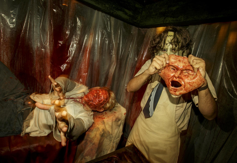 Leatherface scores a trophy at Universal Studios Hollywood’s Halloween Horror Nights 2017. (Photo: David Sprague/Universal Studios Hollywood)