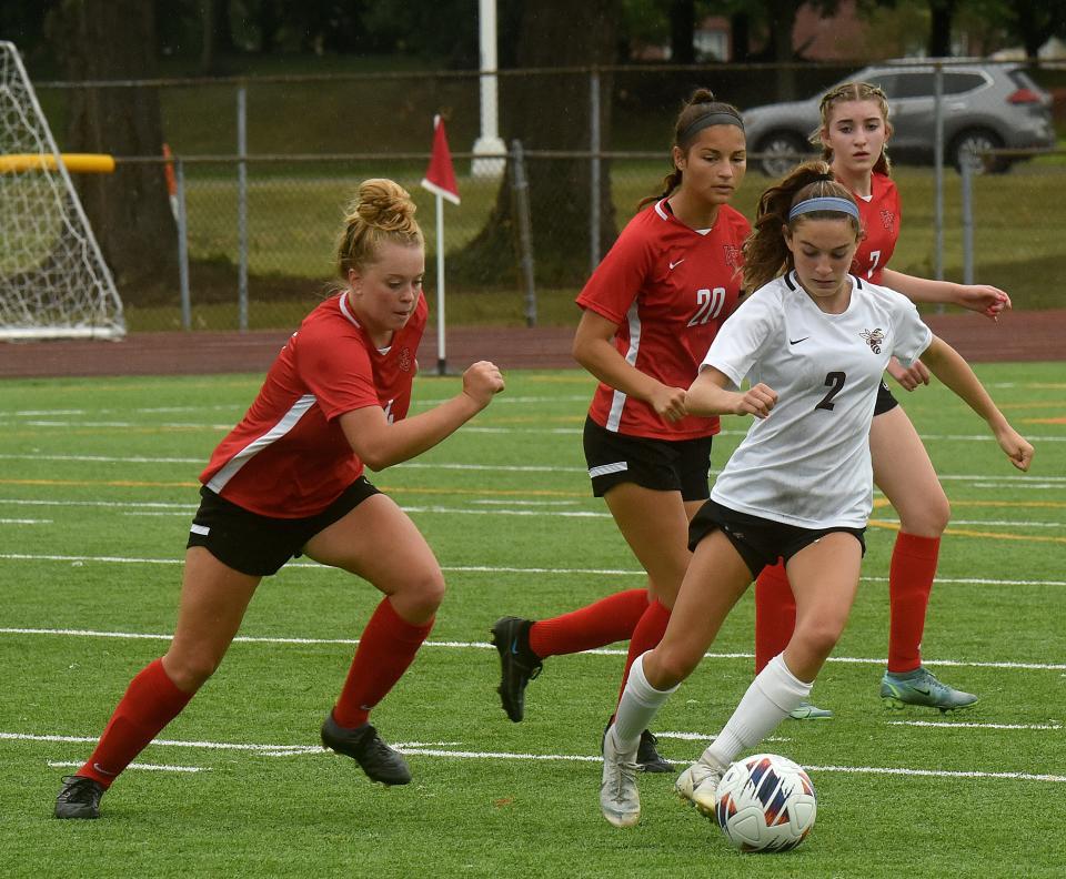 Licking Heights freshman Emma French (right) evades Worthington Christian defenders junior Annie Rettstatt, senior Maria Klausman, and sophomore Bella Kaufman. Th Hornets girls soccer lost 1-0 on the road to Worthington Christian on Saturday, Sept. 3, 2022.