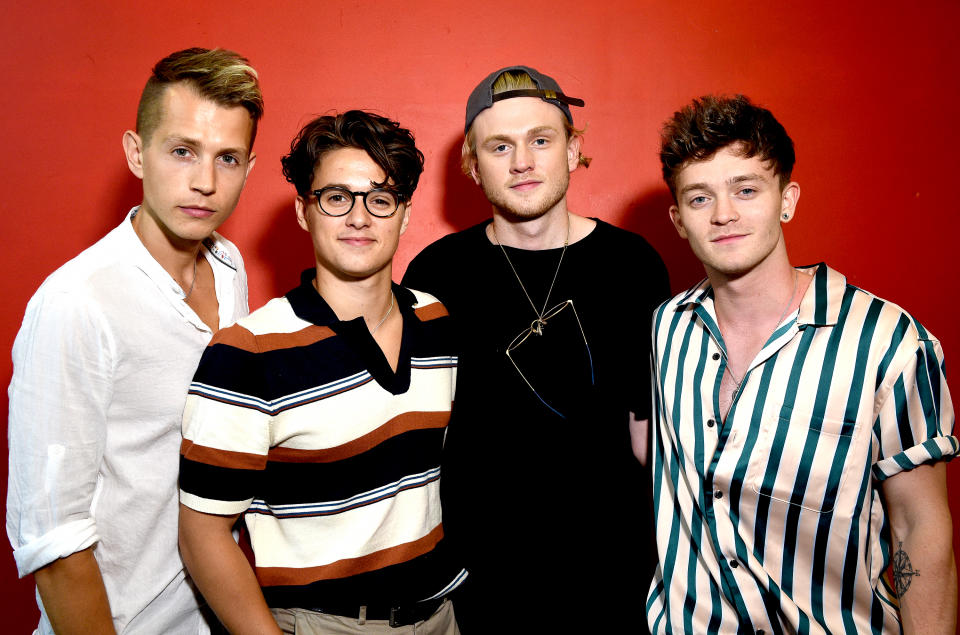 BIRMINGHAM, ENGLAND - JULY 13:  (EXCLUSIVE COVERAGE) James McVey, Bradley Simpson, Tristan Evans and Connor Ball of The Vamps pose backstage after meeting fans and signing copies of their new album 'Night and Day' at HMV Birmingham Bullring on July 13, 2018 in Birmingham, England.  (Photo by Shirlaine Forrest/WireImage)