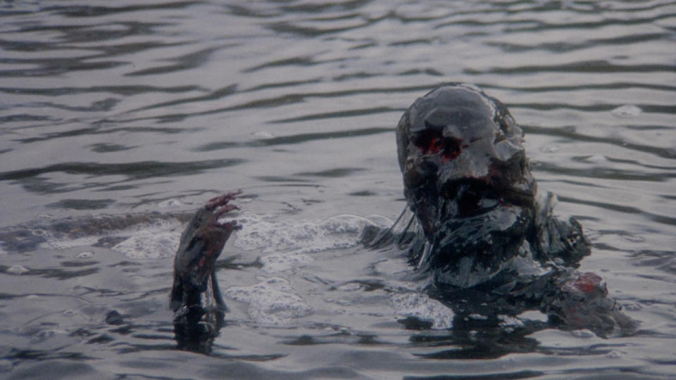 Dead body covered in goo floating in Creepshow 2