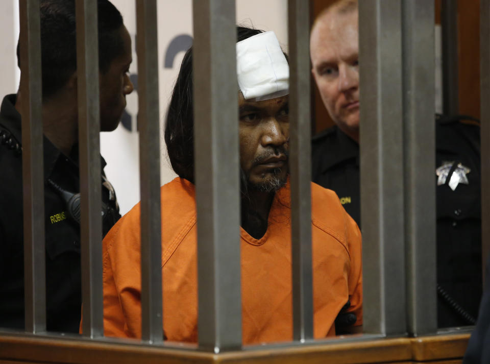 Adel Sambrano Ramos, center, enters a Sacramento County Superior Court room for his first court appearance in the shooting death of Sacramento Police officer Tara O'Sullivan in Sacramento County Superior Court in Sacramento, Calif., Monday, June 24, 2019. Ramos did not enter a plea. A bandage covers Ramos' forehead after he was treated at an outside hospital after he smashed his head against a bed frame Sunday morning, according to officials. (AP Photo/Rich Pedroncelli)