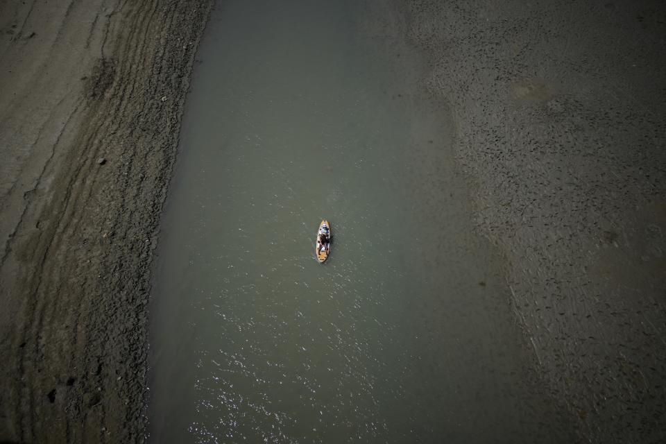 FILE - A paddle boarder passes through a drying portion of the Verdon Gorge in southern France, Aug. 9, 2022. Looking back at 2022’s weather with months of analysis, the World Meteorological Organization says last year really was as bad as it seemed. (AP Photo/Daniel Cole, File)