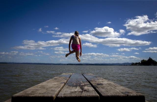 Madilyn Stockinger leaps into Fern Ridge Reservoir while visiting Richardson Park. The lake is a popular destination for those seeking a place to cool off.