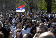 A girl waves with Serbian nation flag during a protest in front of the Serbian Parliament building in Belgrade, Serbia, Saturday, April 10, 2021. Environmental activists are protesting against worsening environmental situation in Serbia. (AP Photo/Darko Vojinovic)