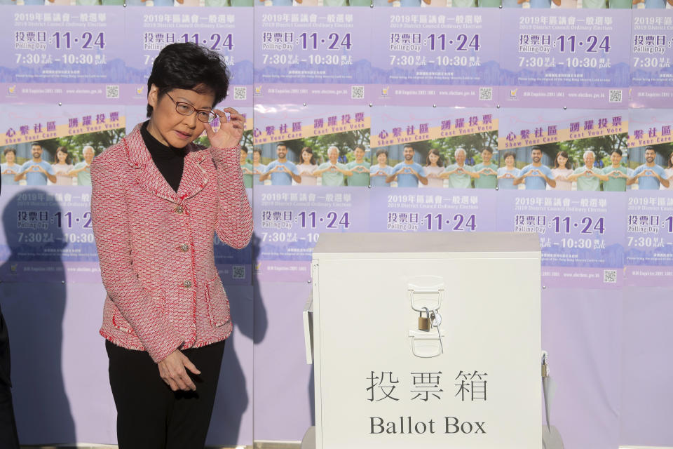 Hong Kong Chief Executive Carrie Lam casts her ballot at a polling place in Hong Kong, Sunday, Nov. 24, 2019. Voting was underway Sunday in Hong Kong elections that have become a barometer of public support for anti-government protests now in their sixth month. (AP Photo/Kin Cheung)