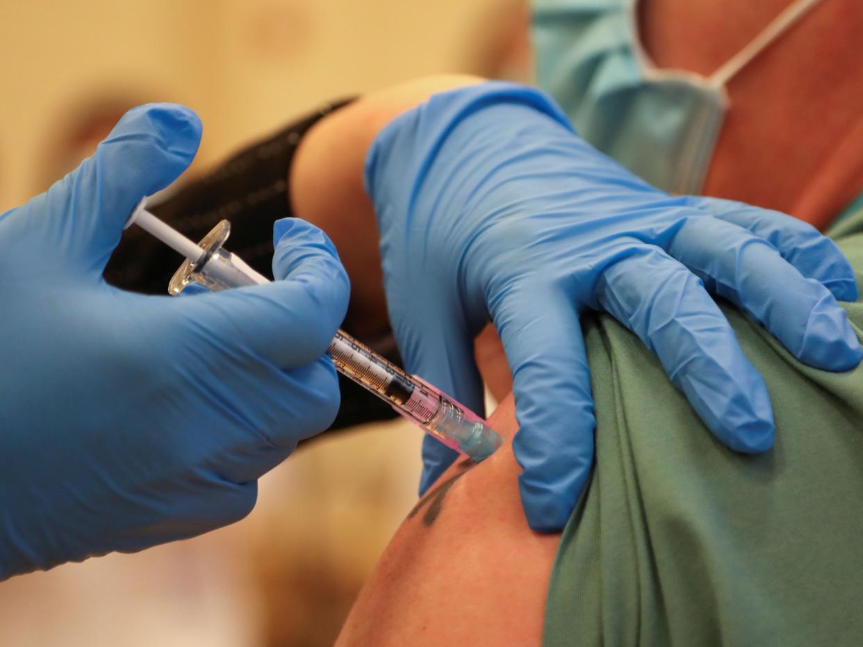 A man is injected with Pfizer’s vaccine at the Michener Institute in Toronto (POOL/AFP via Getty Images)