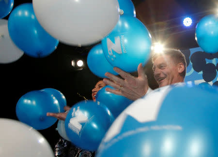 New Zealand Prime Minister Bill English stands among balloons on stage with his wife Mary during an election night event in Auckland, New Zealand, September 23, 2017. REUTERS/Nigel Marple