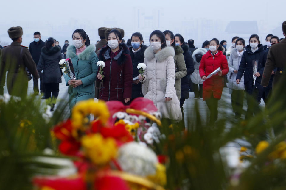 Citizens visit the bronze statues of their late leaders Kim Il Sung and Kim Jong Il on Mansu Hill in Pyongyang, North Korea Thursday, Dec. 16, 2021, on the occasion of 10th anniversary of demise of Kim Jong Il. (AP Photo/Cha Song Ho)