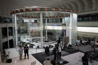 Journalists film an electronic stock board showing reopened Japan's Nikkei 225 index at Tokyo Stock Exchange in Tokyo Friday, Oct. 2, 2020. Tokyo's market resumed trading Friday after a full-day outage due to a malfunction in its computer systems. (AP Photo/Eugene Hoshiko)