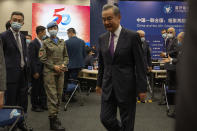 A Chinese United Nations peacekeeper looks on as Chinese Foreign Minister Wang Yi leaves after speaking at a symposium to mark the 50th anniversary of the People's Republic of China's entry into the U.N. at the Foreign Ministry in Beijing on Friday, June 25, 2021. Foreign Minister Wang Yi said China remains deeply committed to United Nations peacekeeping efforts, where more than 2,400 Chinese troops and police are serving, a contribution that underscores China's increasing prominence in the world body. (AP Photo/Ng Han Guan)