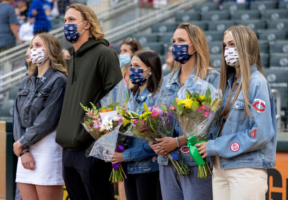 The family of Mike Bell watch a video presentation during a Mike Bell Tribute before a baseball game against the Cincinnati Reds, Monday, June 21, 2021, in Minneapolis. Twins bench coach Mike Bell passed away from cancer in March.