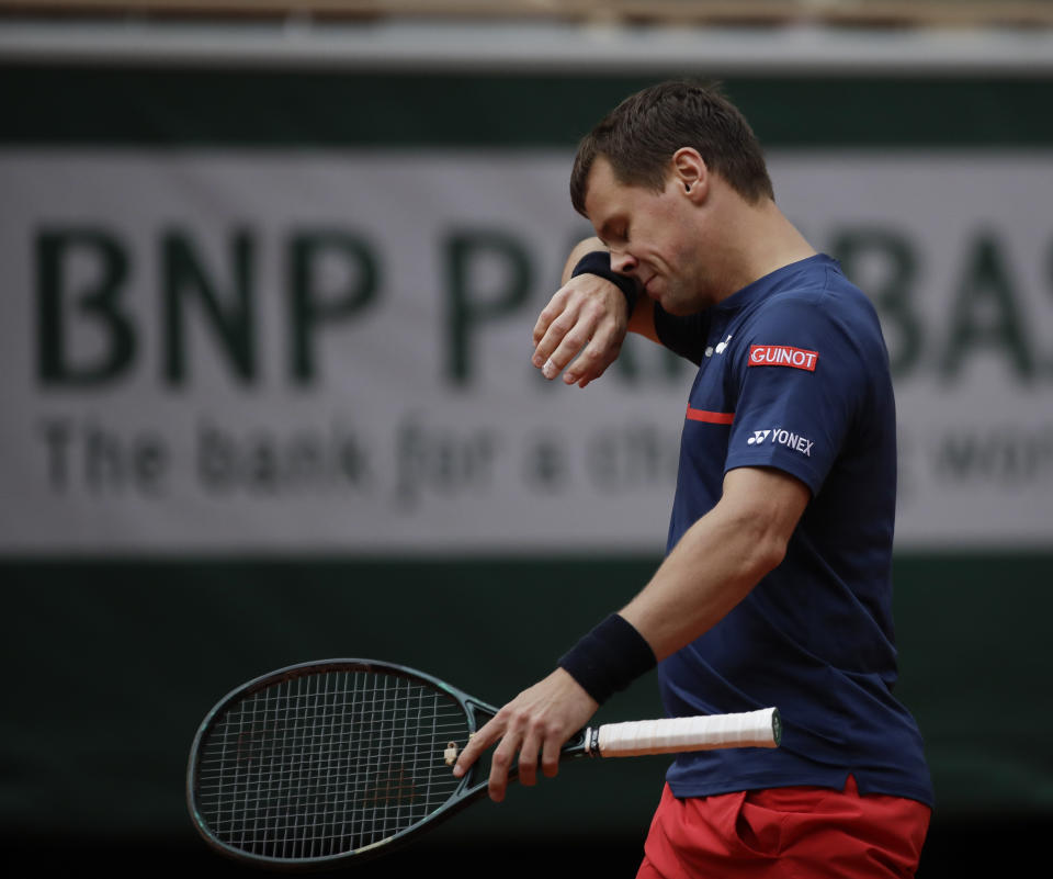 Lithuania's Ricardas Berankis wipes his face in his match against Serbia's Novak Djokovic in the second round of the French Open tennis tournament at the Roland Garros stadium in Paris, France, Thursday, Oct. 1, 2020. (AP Photo/Alessandra Tarantino)