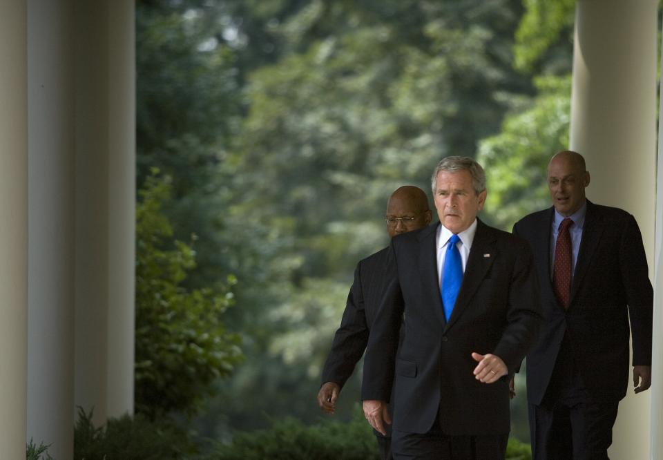 WASHINGTON - AUGUST 31:  U.S. President George W. Bush walks to the Rose Garden of the White House with Secretary of the United States Department of Housing and Urban Development Alphonso Jackson (L) and Secretary of the Treasury Henry M. Paulson Jr. (R) August 31, 2007 in Washington, DC.  Joined by Secretary of the Treasury Henry M. Paulson Jr. and Alphonso Jackson, Secretary of the United States Department of Housing and Urban Development, President Bush spoke about the defaulting home loan crisis and the economy.  (Photo by Brendan Smialowski/Getty Images)