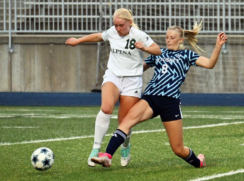 Petoskey's Lily Premo works to get a foot on the ball to disrupt it from an Alpena player during Thursday's BNC match at Northmen Stadium.