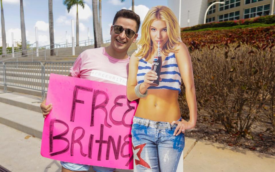 A supporter of Britney Spears holds a sign during a #FreeBritney protest outside American Airlines Arena  - Getty