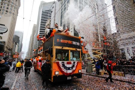 Oct 31, 2014; San Francisco, CA, USA; San Francisco Giants manager Bruce Bochy waves to fans from the top of a bus during the World Series victory parade on Market Street. Mandatory Credit: Kelley L Cox-USA TODAY Sports