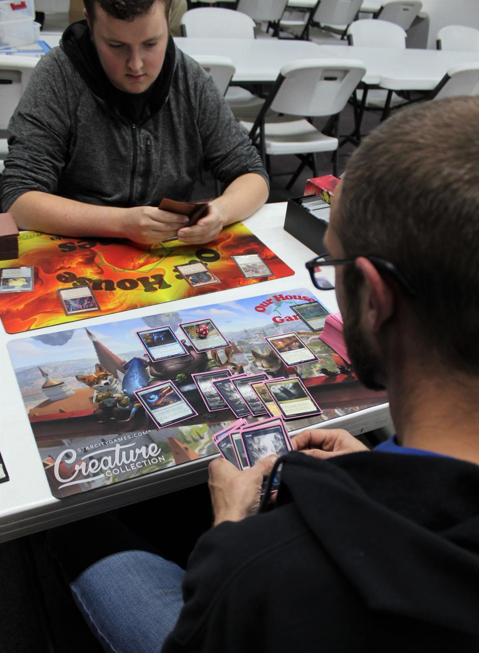 It’s game night for Monroe residents Ian Koebel (left) and Nick West as they play the card game, Magic: The Gathering.