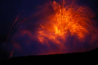 Lava from the Pu'u O'o crater eruption of Hawaii's Kilauea volcano, active since 1983, meets the ocean and large littoral explosions from steam result. This photo was taken on July 16, 2008.