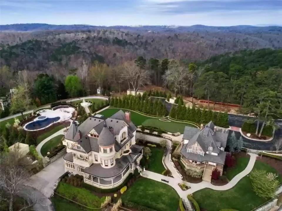 multi-family home with a pool and various paths in heavily wooded Arkansas