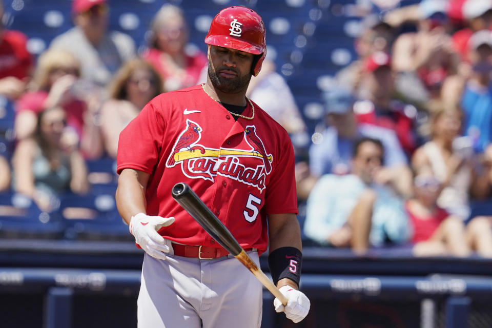 St. Louis Cardinals' Albert Pujols (5) looks at his bat in the first inning of a spring training baseball game against the Washington Nationals, Wednesday, March 30, 2022, in West Palm Beach, Fla. (AP Photo/Sue Ogrocki)