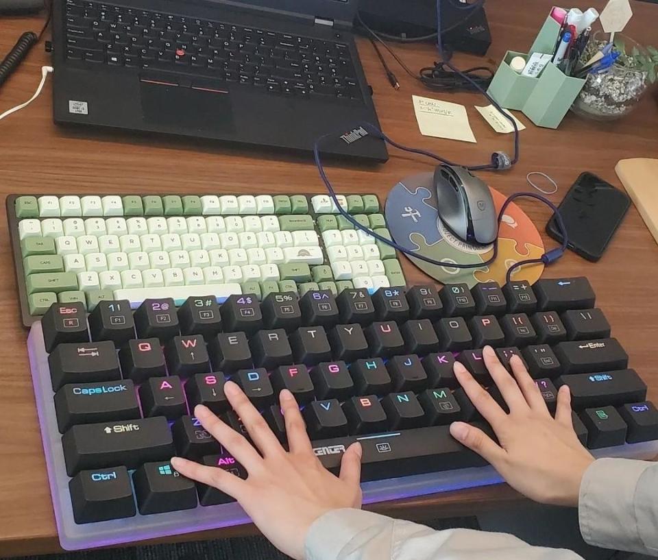 a person's hands using a giant keyboard