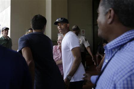 Former Yankees closer pitcher Mariano Rivera (C) is seen during a visit with the New York Yankees team at the Panama Canal in Panama City March 14, 2014. REUTERS/Carlos Jasso