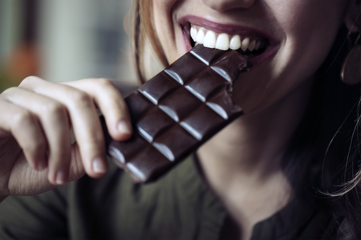 Woman eating a chocolate bar