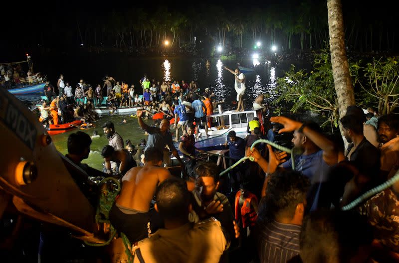 Rescuers search for survivors after a boat capsized off the coastal town of Tanur