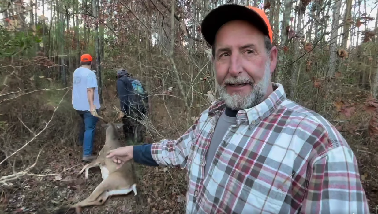 A screen capture of Brad Slaybaugh pointing at the buck his brother Dave harvested in Surry in November 2023.