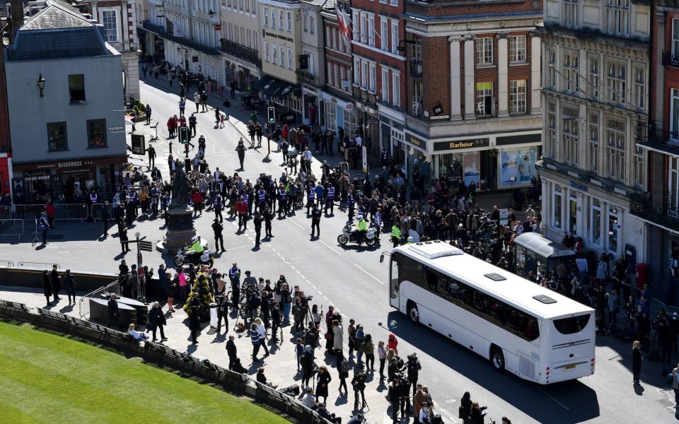 Police hold back the crowds as a coach arrives outside St George's Chapel, Windsor Castle - Justin Tallis/PA