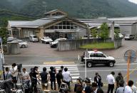 Journalists gather at the main gate of the Tsukui Yamayuri En care centre where a knife-wielding man went on a rampage in Sagamihara, Japan's Kanagawa prefecture, early on July 26, 2016
