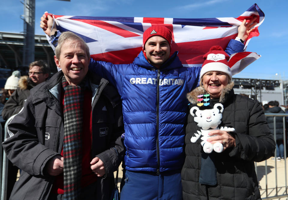 Dom Parsons poses with his parents after getting a bronze medal in the men's skeleton.