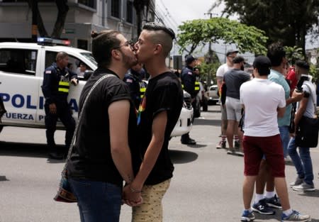 A gay couple kisses as they take part in the annual Gay Pride parade along Central Avenue, in San Jose