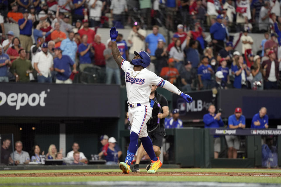 Texas Rangers' Adolis Garcia celebrates after hitting a home run against the Houston Astros during the second inning in Game 4 of the baseball American League Championship Series Thursday, Oct. 19, 2023, in Arlington, Texas. (AP Photo/Julio Cortez)