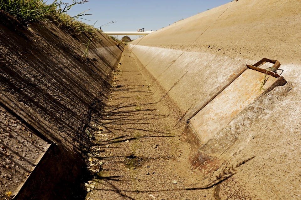 Salt is left on the walls of an irrigation canal on Bobby Costa’s cucumber farm near Tracy, Calif., on Thursday, July 21, 2022. In dry winters like the one California just had, saltier water from the Pacific Ocean intrudes further into rivers used for farming and drinking. “We just try to hang on and hope the water quality gets better," said Costa, who has seen his cucumber yields go down by 25% this year compared to a wetter year. (AP Photo/Rich Pedroncelli)