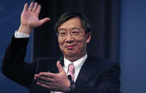 Yi Gang, Deputy Governor of the People's Bank of China, waves during a CNN Debate on the Global Economy at George Washington University during the annual World Bank - International Monetary Fund meetings in Washington, DC, October 10, 2013